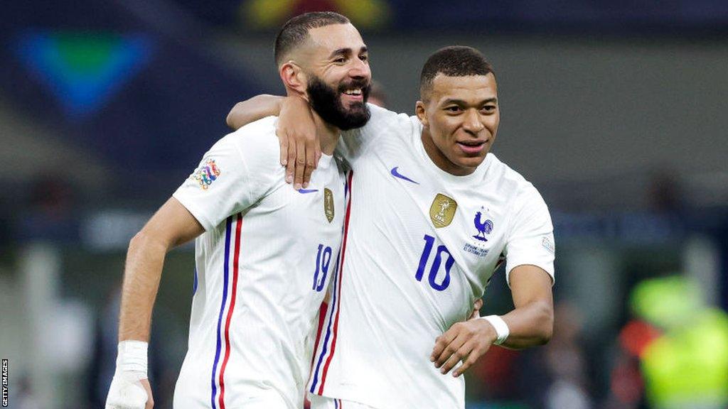 Karim Benzema and France team-mate Kylian Mbappe embrace each other