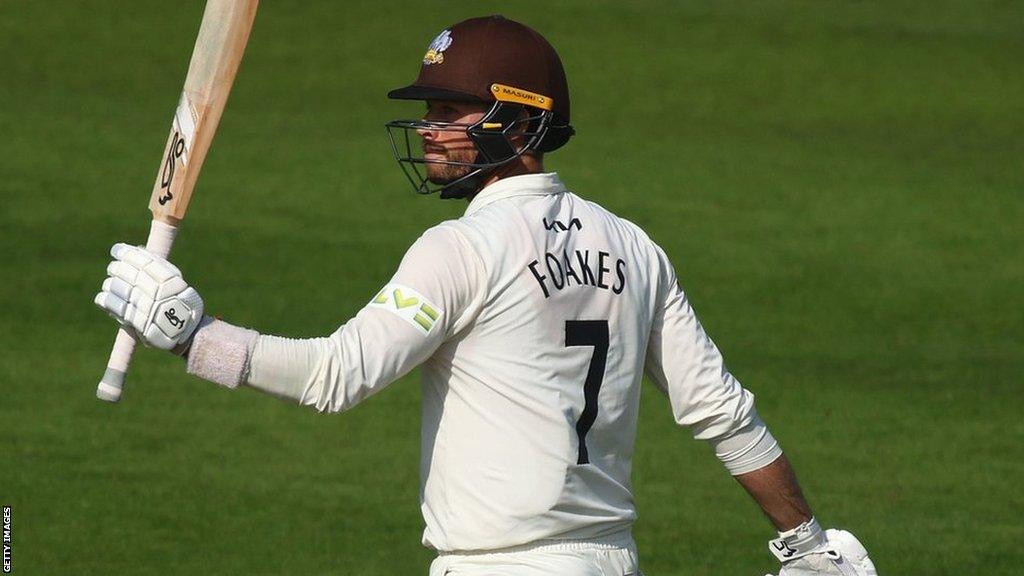 Ben Foakes raises his bat aloft after making his 16th first-class century - and his 10th for Surrey