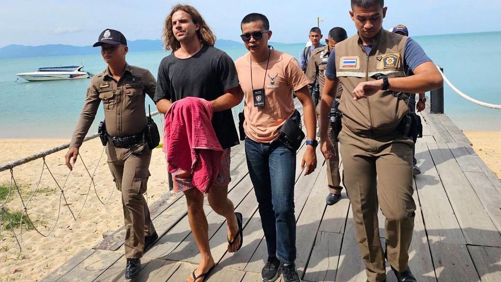 Daniel Sancho Bronchalo (2nd L) being escorted by Thai police during a reenactment of his alleged homicide in August 2023