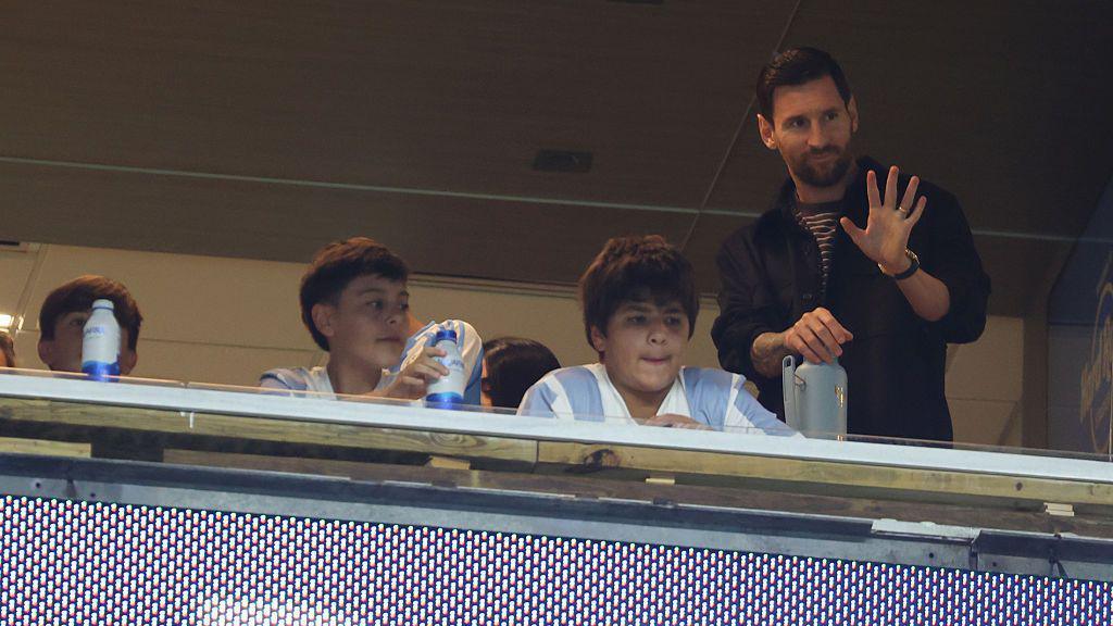 Lionel Messi waves from the stands