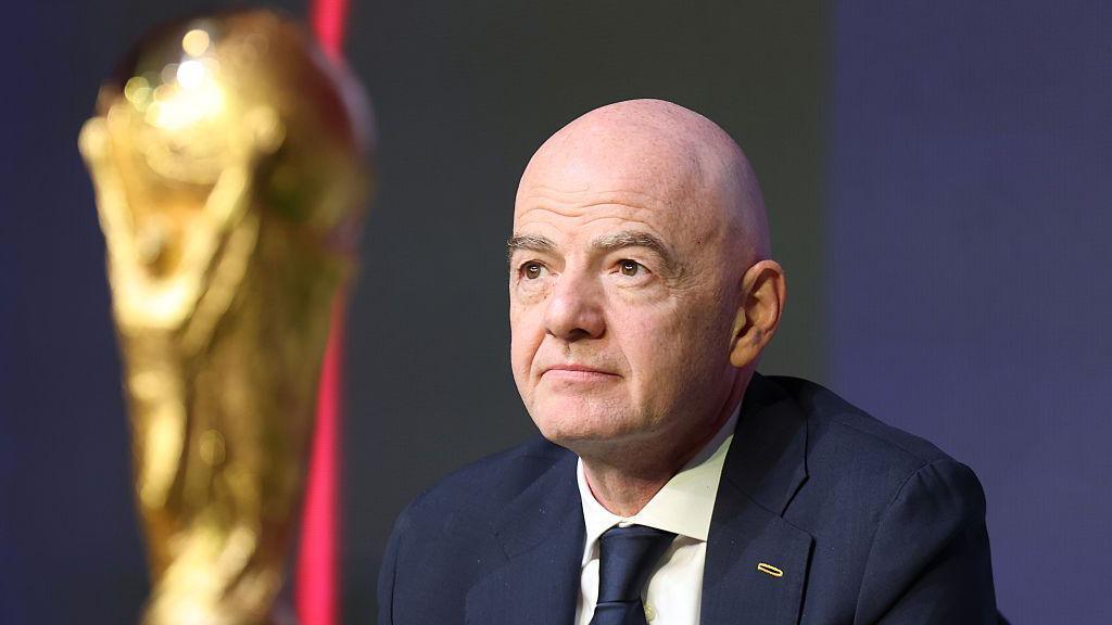 Fifa president Gianni Infantino and the World Cup trophy at the draw 