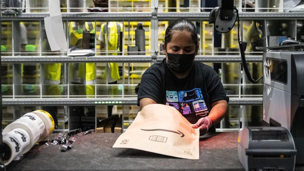 A worker prepares packages at an Amazon same-day delivery fulfillment center on Prime Day in the Bronx borough of New York, US, on Tuesday, July 16, 2024