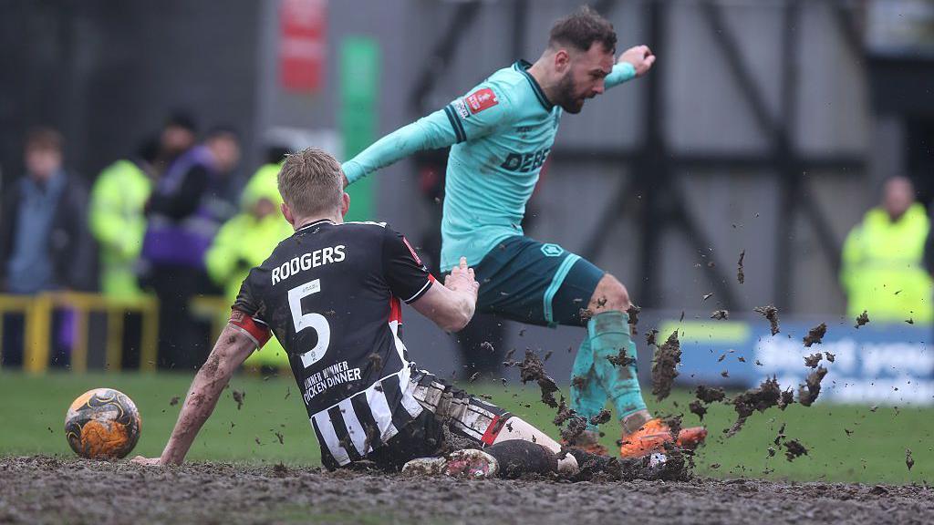 Adam Armstrong of Wolves and Harvey Rodgers of Grimsby Town battle for possession 