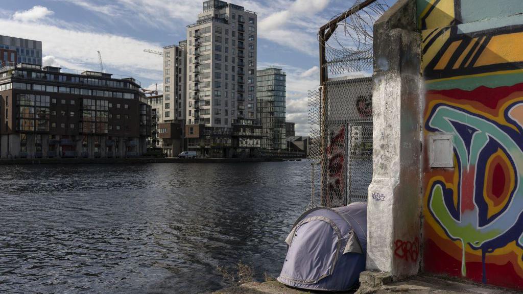 A tent belonging to homeless people pitched at the edge of the water in the Silicon Docks area in central Dublin, Ireland