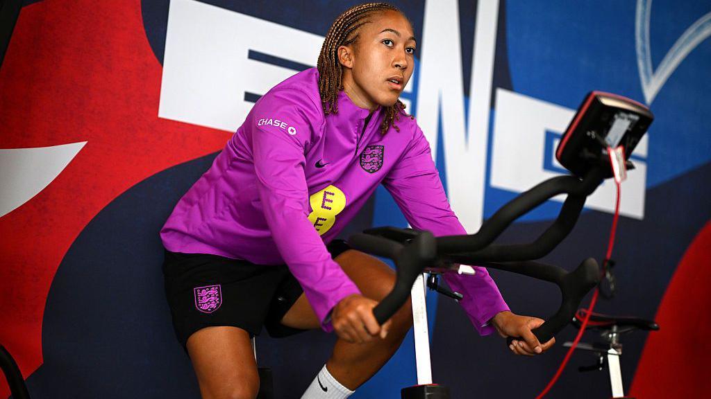 Lauren James on an exercise bike