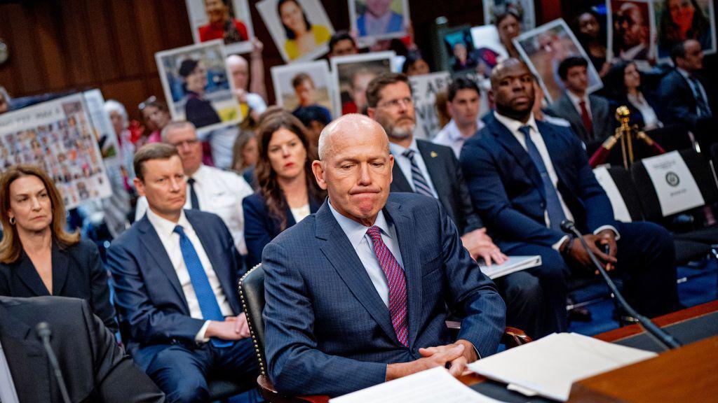 Family members of those killed in the Ethiopian Airlines Flight 302 and Lion Air Flight 610 crashes hold photographs of their loved ones as Boeing CEO Dave Calhoun arrives for a Senate Homeland Security and Governmental Affairs Investigations Subcommittee hearing on Boeing's broken safety culture on Capitol Hill on June 18, 2024 in Washington, DC 