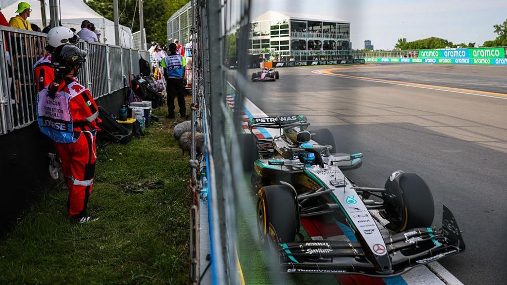 Mercedes' George Russell comes within inches of the wall on the start-finish straight at the Canadian Grand Prix with marshals stood just the other side of the barrier