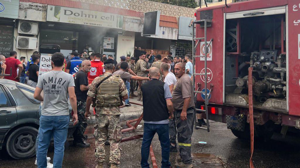  first responders gather at the scene of a reported device explosion in Saida in southern Lebanon 