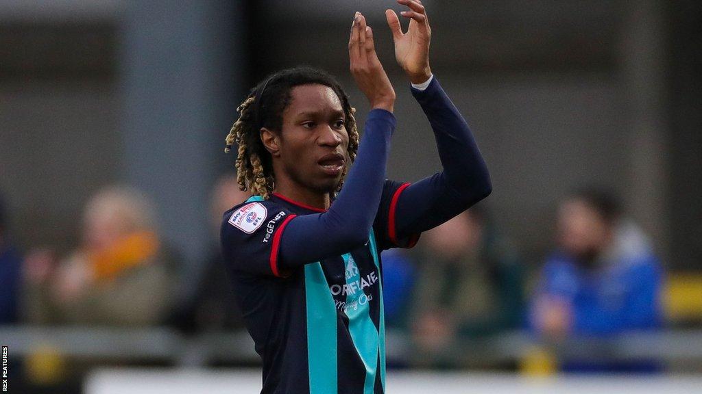 Tariq Uwakwe applauds Crewe Alexandra fans following a match