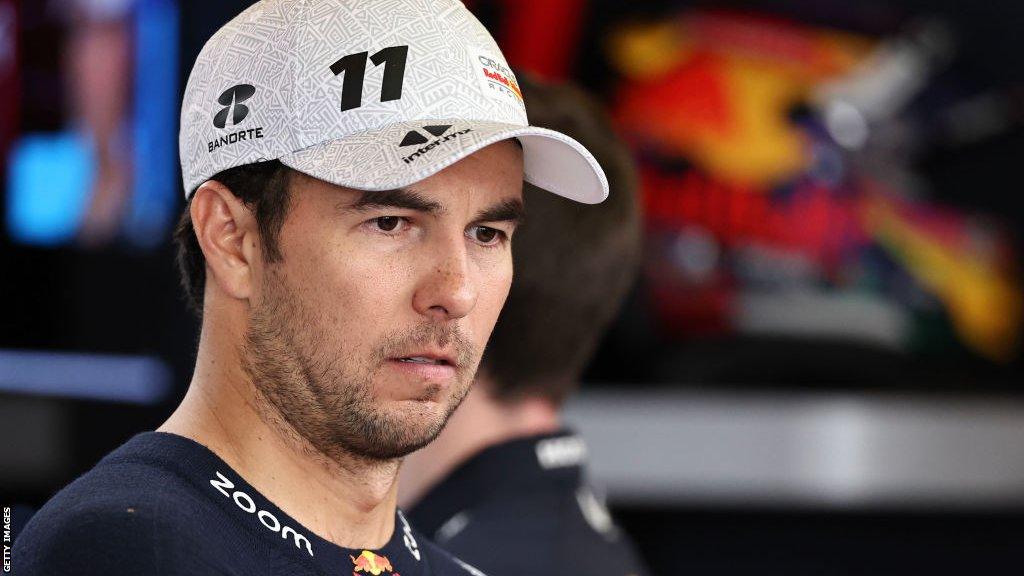 Sergio Perez looks forlorn in the Red Bull Racing F1 garage