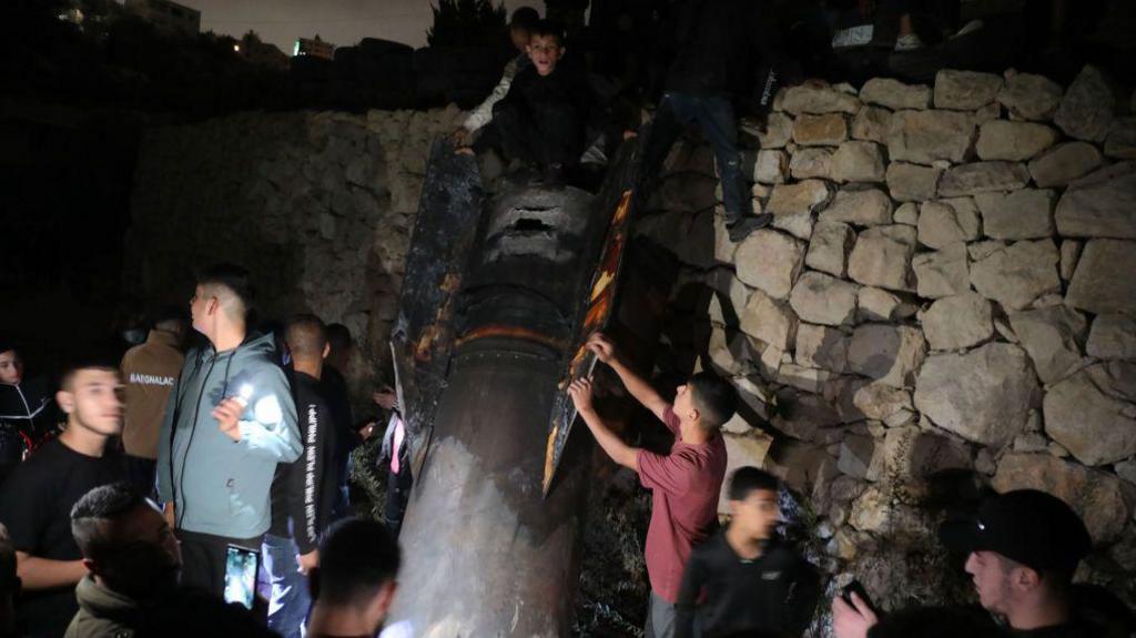 Palestinians inspect debris of a missile fired from Iran to Israel, after it falls on an area in Luza neighborhood, Hebron Governorate in West Bank on October 1, 2024. 