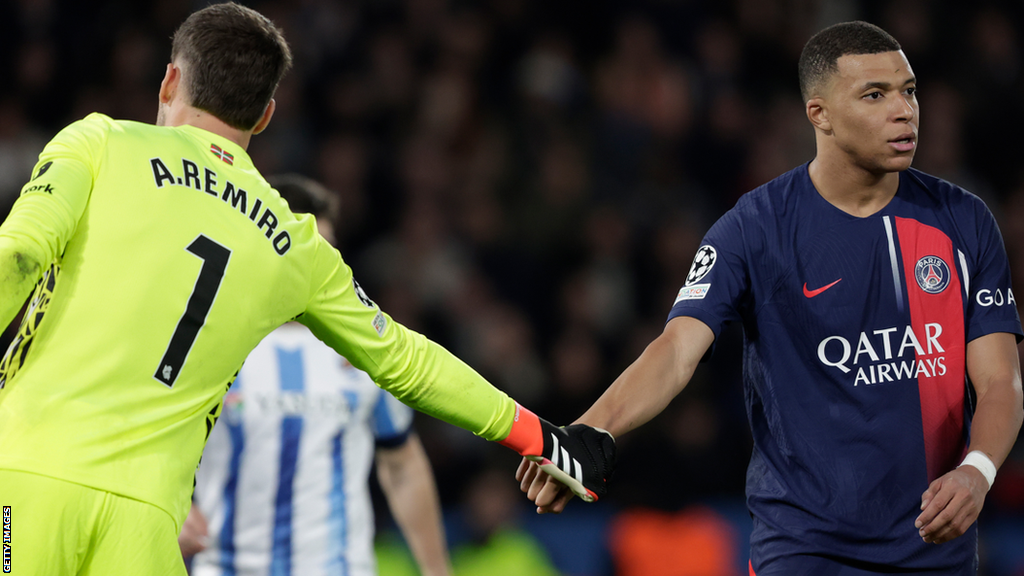 Real Sociedad keeper Alex Remiro shakes hands with Paris St-Germain forward Kylian Mbappe during the Champions League tie between the two clubs