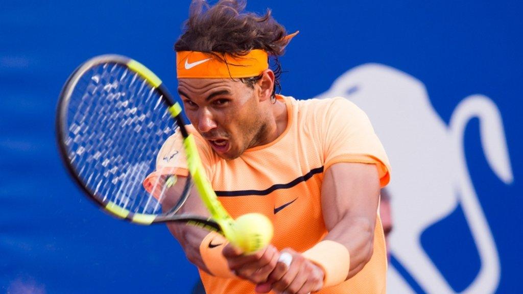 Rafael Nadal plays a backhand