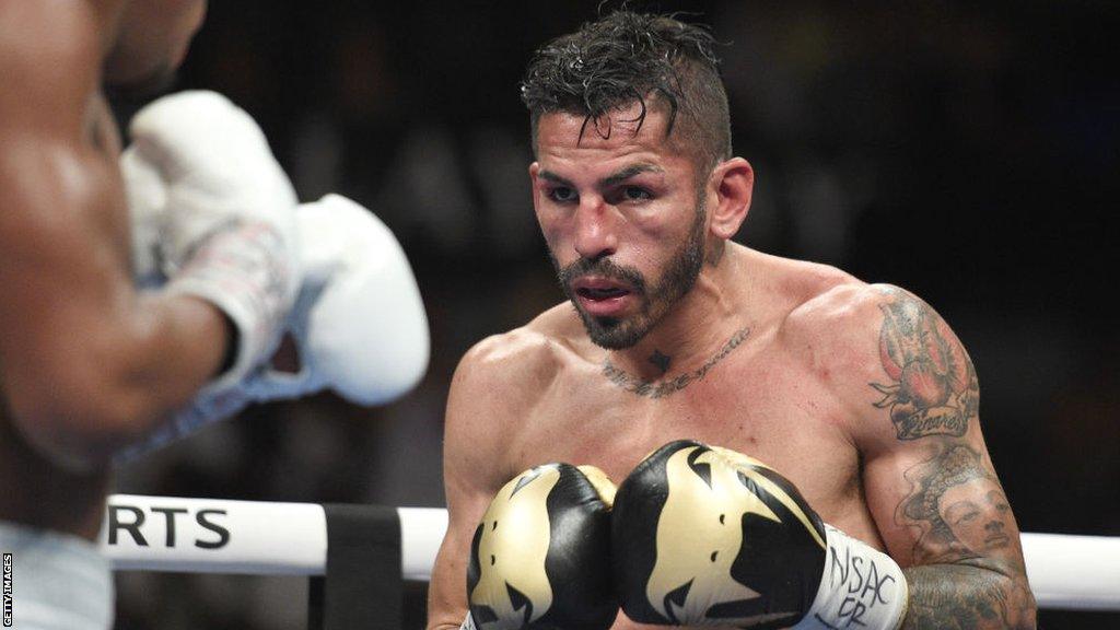 A marked up Jorge Linares looks at opponent Devin Haney