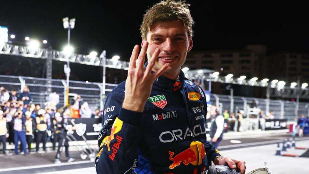Max Verstappen holds up four fingers to the camera to celebrate winning the 2024 drivers' championship at the Las Vegas Grand Prix