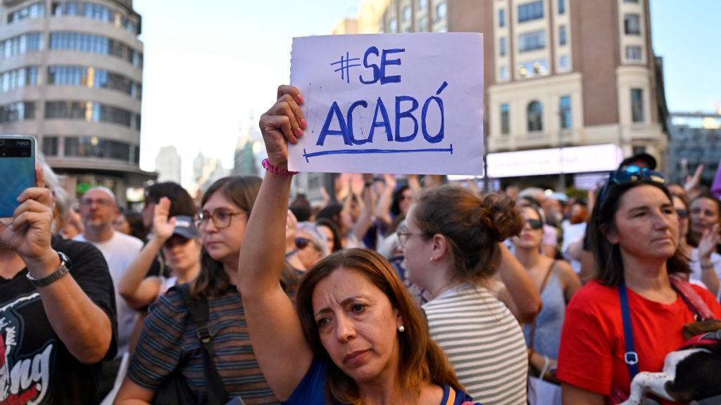 A protestor holds a sign reading "se acabo" ("it's over") during a demonstration called by feminist associations in support to Spain midfielder Jenni Hermoso, on Callao square in Madrid on 28 August 2023. 