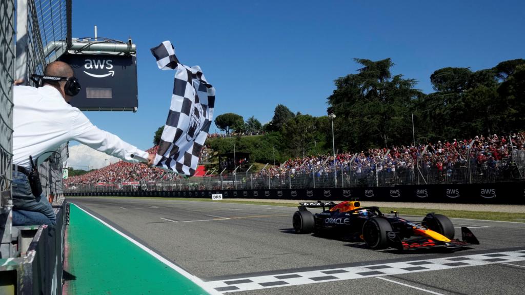 The chequered flag is waved as Max Verstappen crosses the line to win the Emilia-Romagna Grand Prix