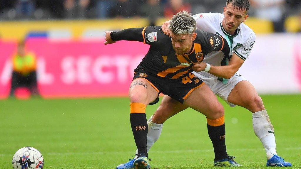 Plymouth Argyle defender Julio Pleguezuelo (right) battles for the ball with Hull City striker Aaron Connolly