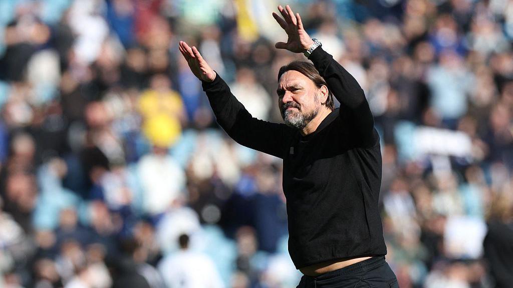 Leeds United's German head coach Daniel Farke gestures to fans on the pitch