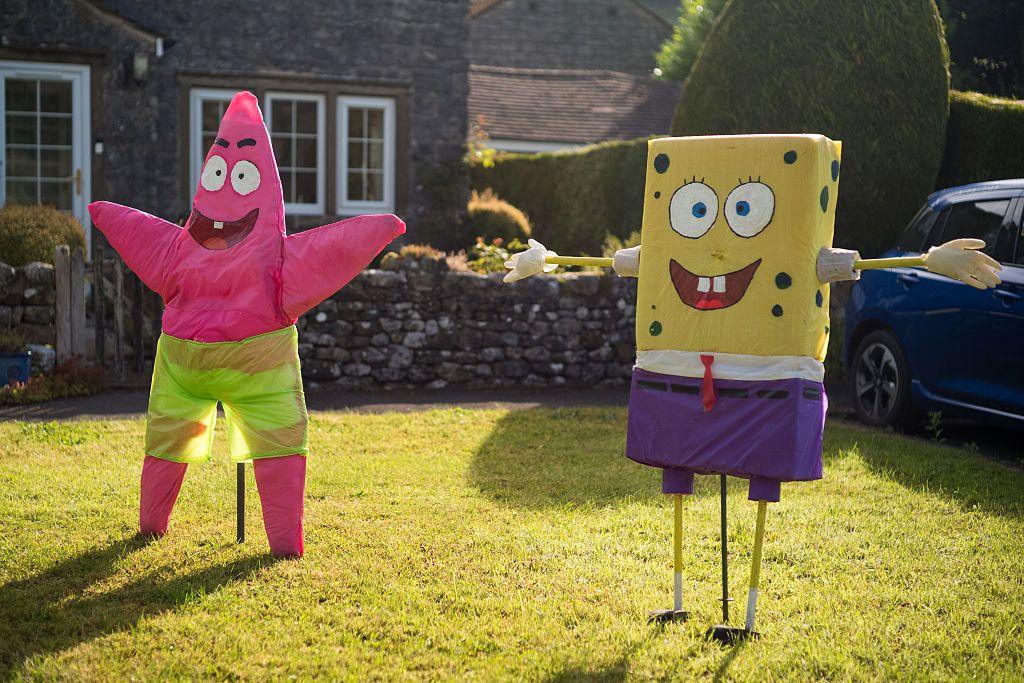 Models of SpongeBob SquarePants and Patrick from the TV show are seen in front of a row of houses.