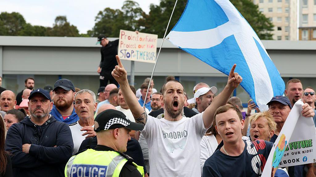 Protesters demonstrate against what they call uncontrolled immigration outside the Cladhan Hotel in Falkirk on 16 August.