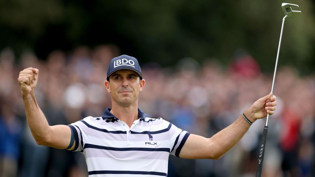 Billy Horschel holds up his arms pinch a play nine successful his near hand