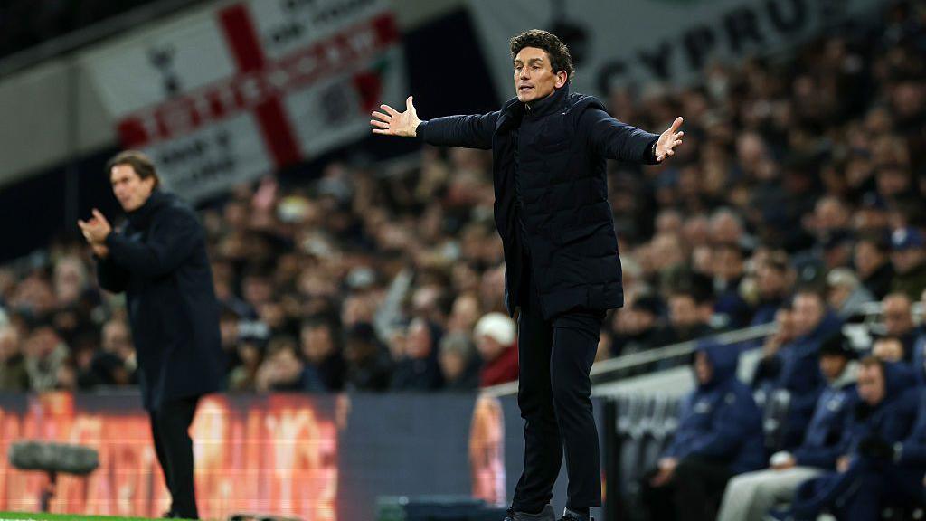 Keith Andrews throws his arms in the air