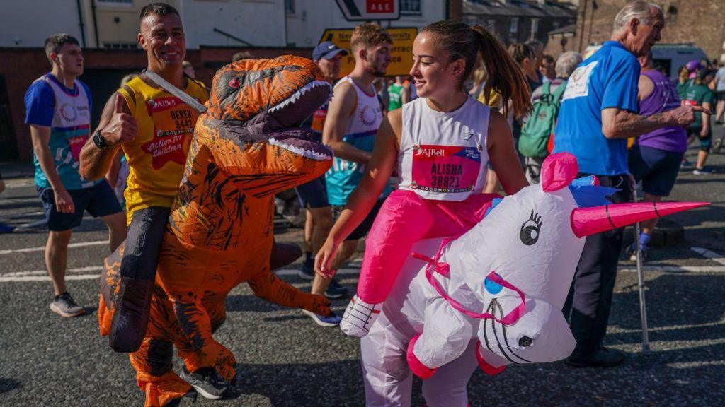 Runners in fancy dress head to the start line in The Great North Run 2024.