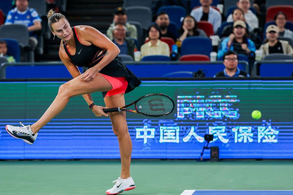 Aryna Sabalenka plays a shot through her legs in her semi-final defeat by Jessica Pegula at the Wuhan Open in China