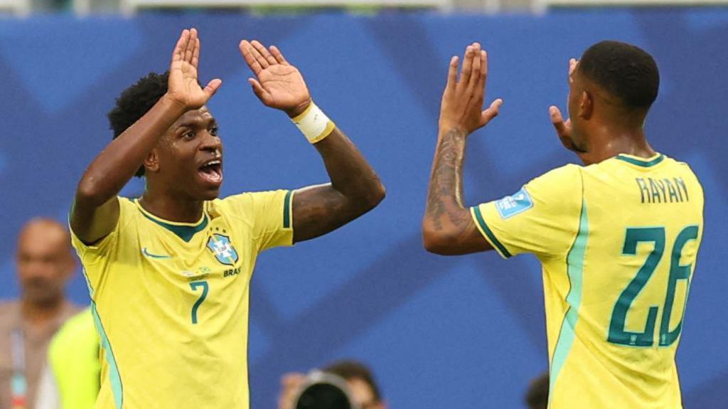 Rayan celebrates a Brazil goal with Vinicius Junior