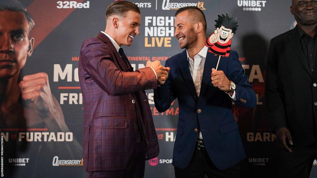 Dennis McCann and Ionut Baluta grin at each other during a face-off