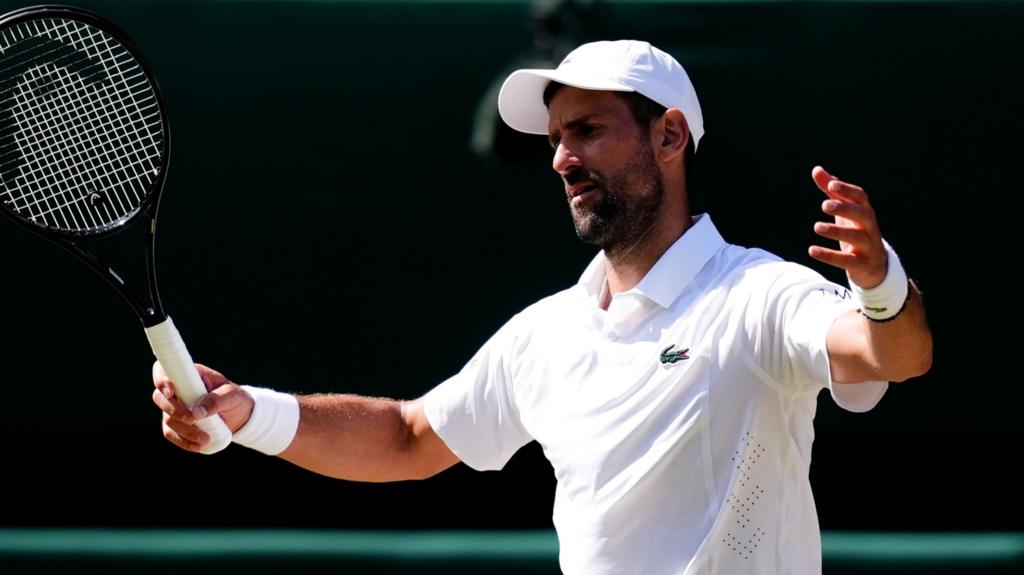 Roman Safiullin and Novak Djokovic during their Wimbledon match