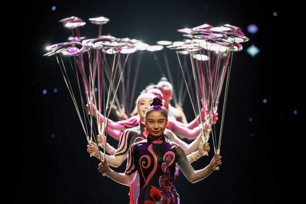 Acrobats spinning plates on poles