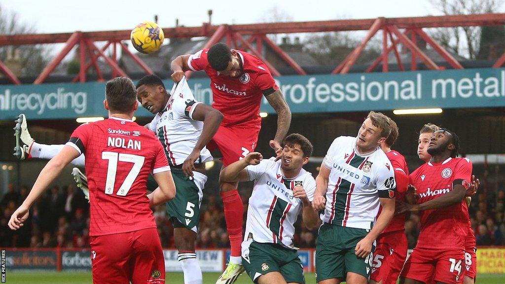 Accrington and Wrexham players battling for the ball