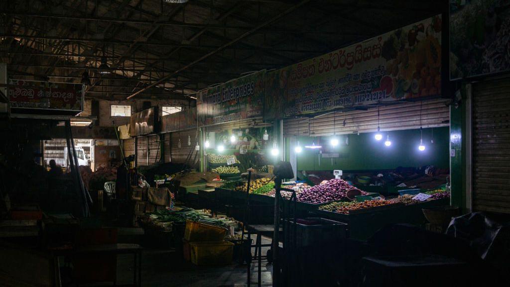 Fruit stalls are seen in Kirimandala Market during a power cut in Colombo, Sri Lanka, on 12 April 2022.