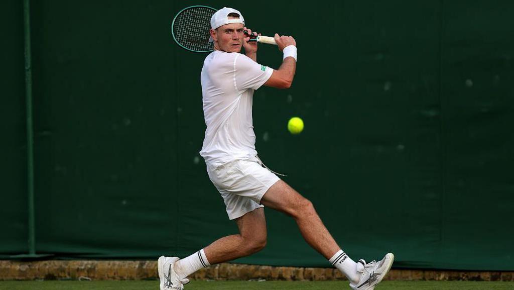 Briton Jack Pinnington Jones prepares to play a backhand at the Wimbledon Championships 