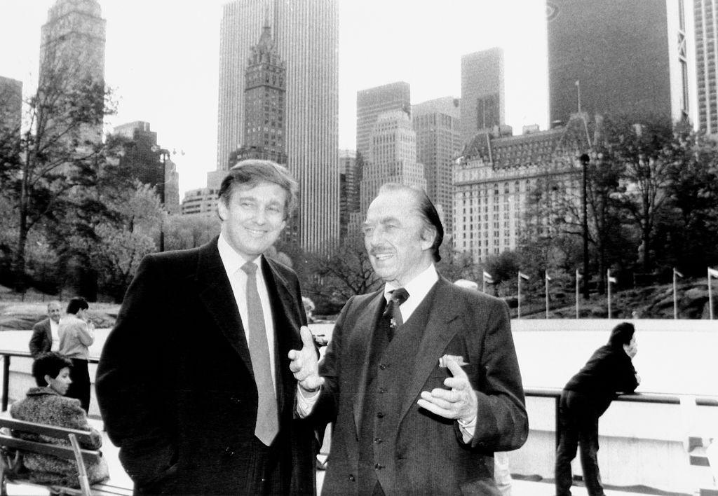 A black and white picture of Donald Trump with his father Fred in New York against a backdrop of skyscrapers