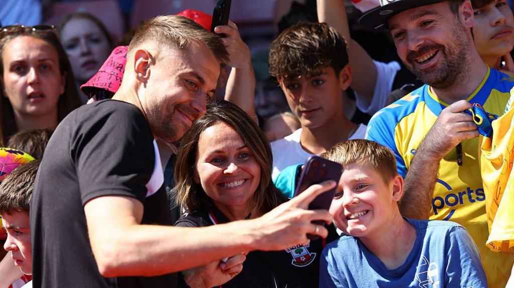Tonda Eckert greets fans during an open training session