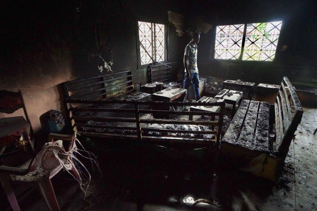 A local man walks through a burnt-out restaurant on 11 May 2019 in Buea in southern Cameroon