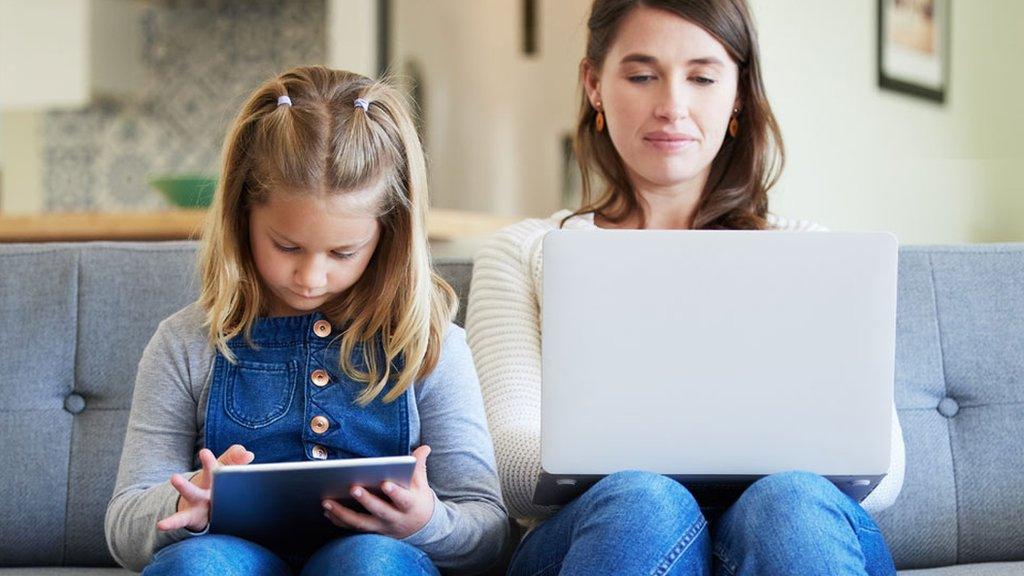 a stock image of a father and son looking at the internet