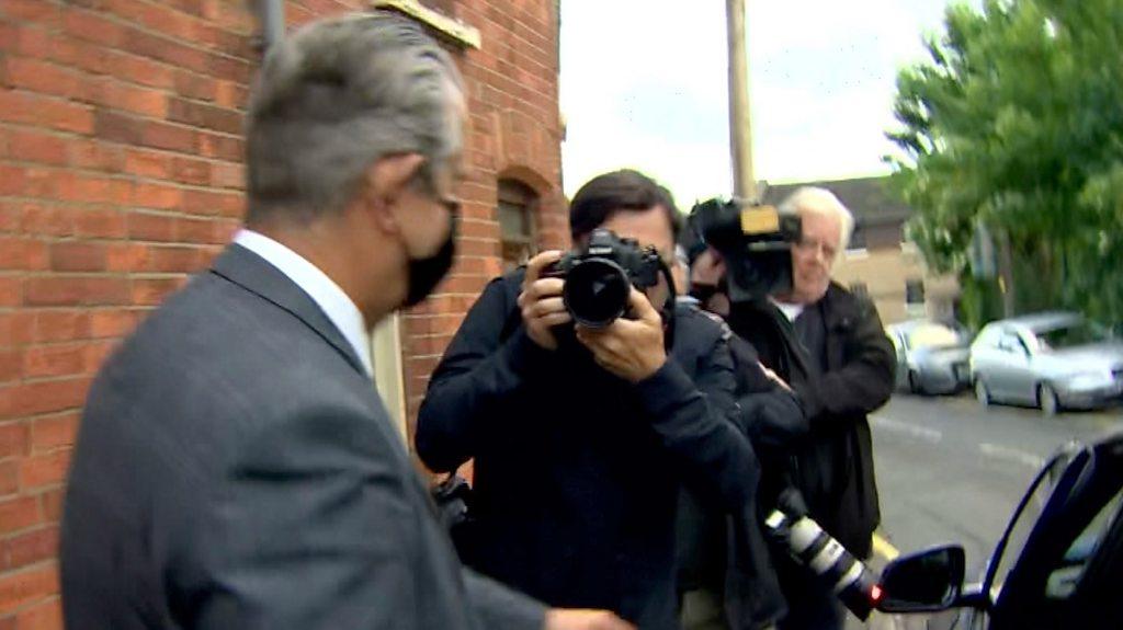 Edwin Poots surrounded by press