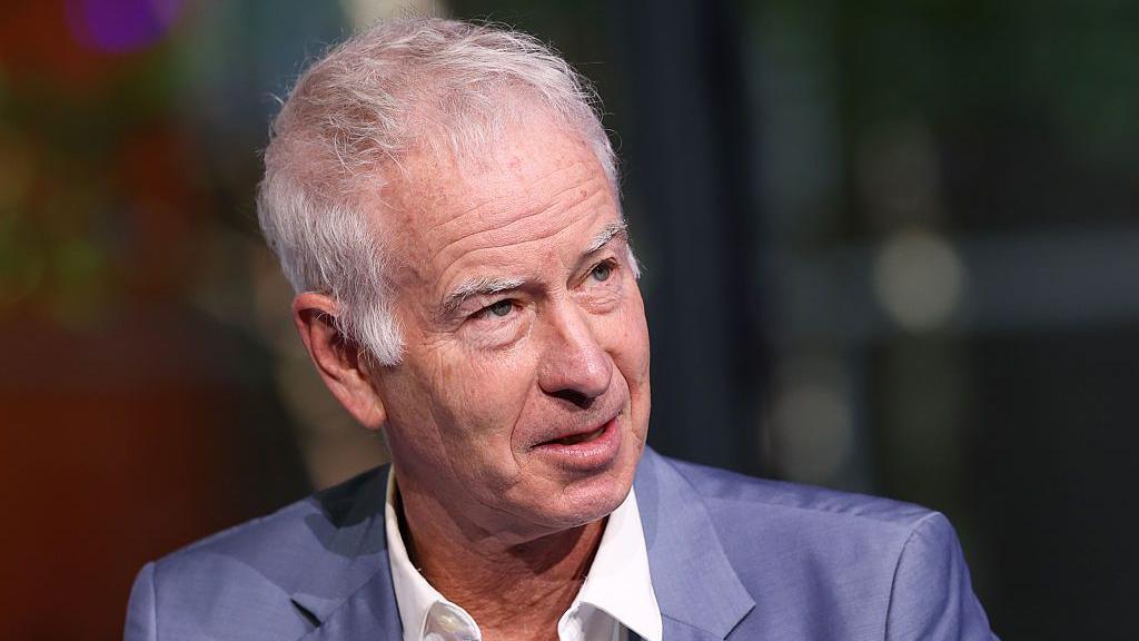 John McEnroe looks on