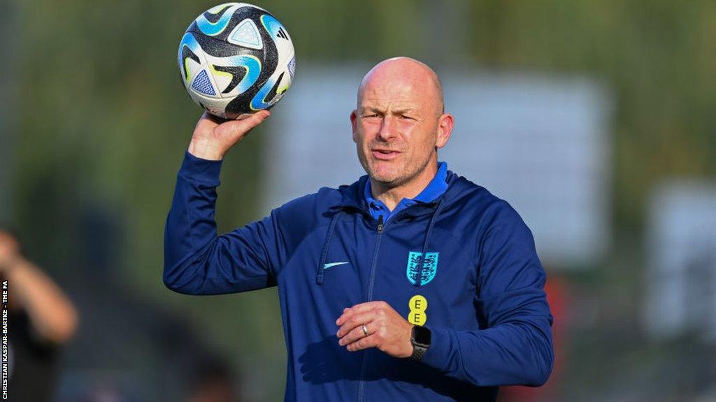 Lee Carsley throws a ball during a training session