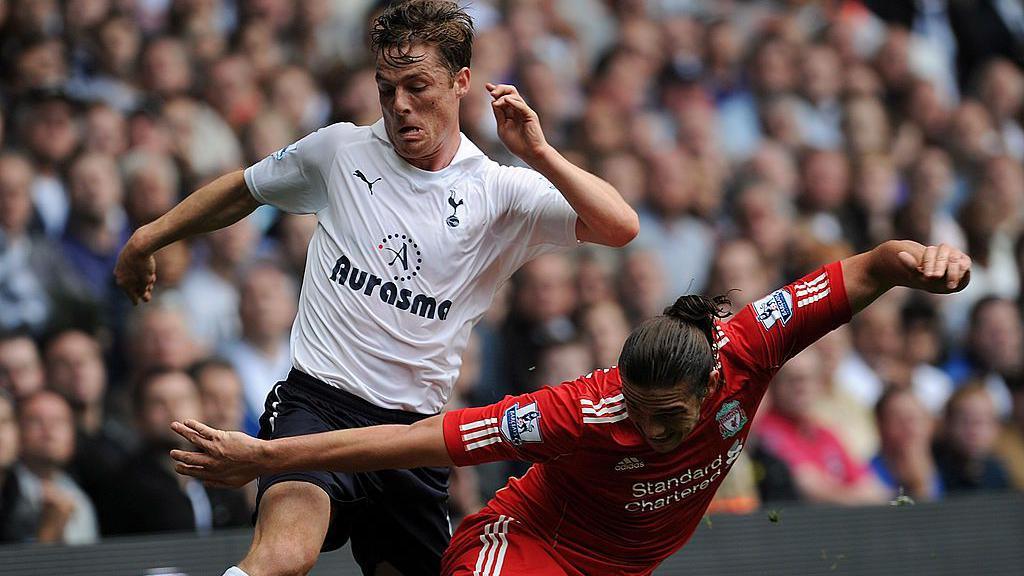 Tottenham's Scott Parker challenges Liverpool's Andy Carroll for the ball in a Premier League match in 2011