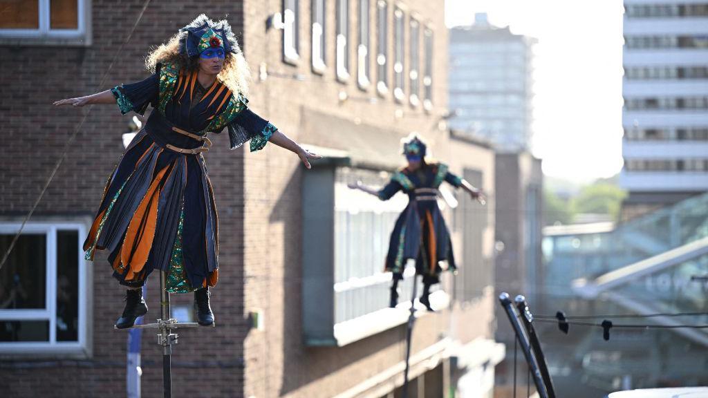 Performers with the French acrobatics company Gratte Ciel present the world premiere of their show 'The Awakening' in Coventry, central England, on May 13, 2022