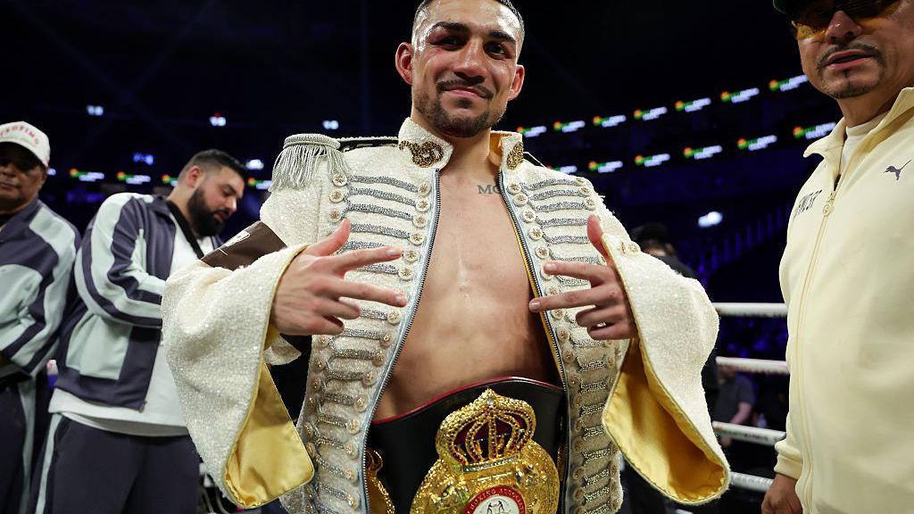 Teofimo Lopez celebrates with his world title aroud his waist