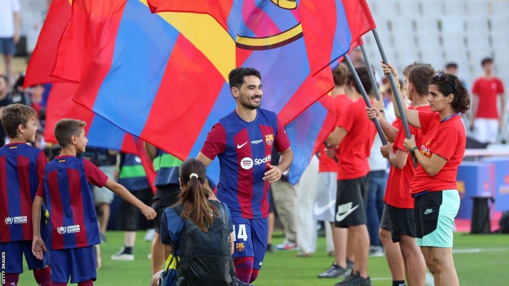 Ilkay Gundogan walks out onto the pitch during a pre-season game for Barcelona