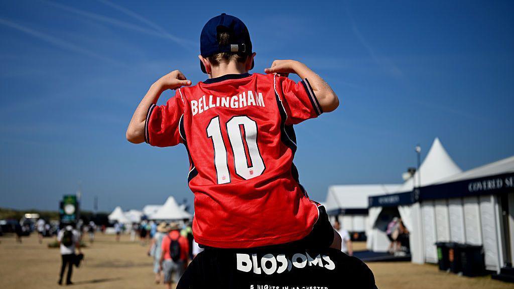 A young England fan takes in a practice round at the Open championship
