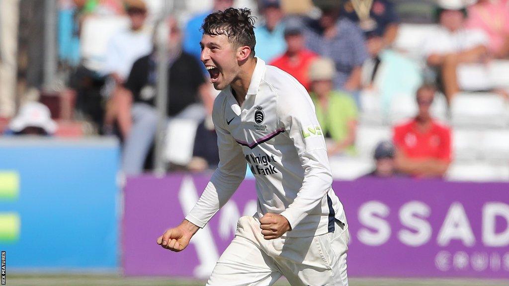 Josh de Caires clenches his fists in celebration at taking a wicket against Essex