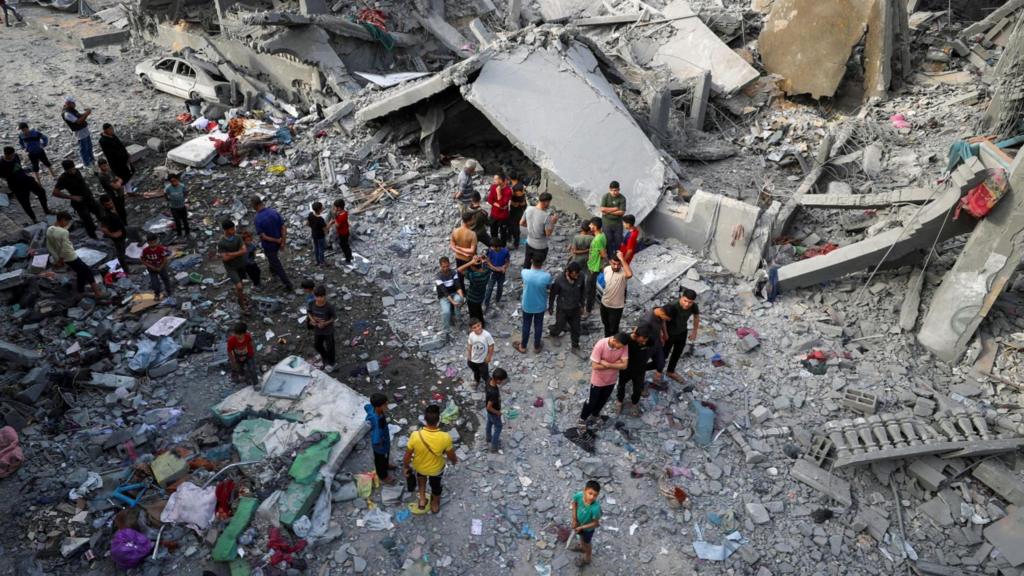 Palestinians inspect the site of an Israeli strike on a house, in Jabalia, northern Gaz